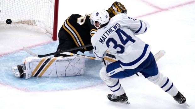 Toronto Maple Leafs center Auston Matthews (34) beats Boston Bruins goaltender Linus Ullmark, back, for a goal during the third period of Game 2 of an NHL hockey Stanley Cup first-round playoff series, Monday, April 22, 2024, in Boston. (AP Photo/Charles Krupa)