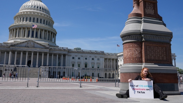 Jennifer Gay, a TikTok content creator, sits outside the U.S. Capitol, Tuesday, April 23, 2024, in Washington as Senators prepare to consider legislation that would force TikTok’s China-based parent company to sell the social media platform under the threat of a ban, a contentious move by U.S. lawmakers. (AP Photo/Mariam Zuhaib)