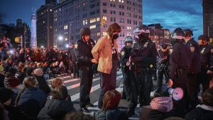 Police arrest protesters as they block traffic during a pro-Palestinian demonstration in the Brooklyn borough of New York, Tuesday, April 23, 2024. (AP Photo/Andres Kudacki)