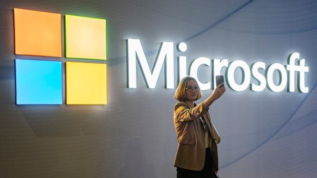 A visitor takes a photo at the Microsoft stand at Mobile World Congress 2024 in Barcelona, Spain, Feb. 27, 2024. (AP Photo/Pau Venteo) 