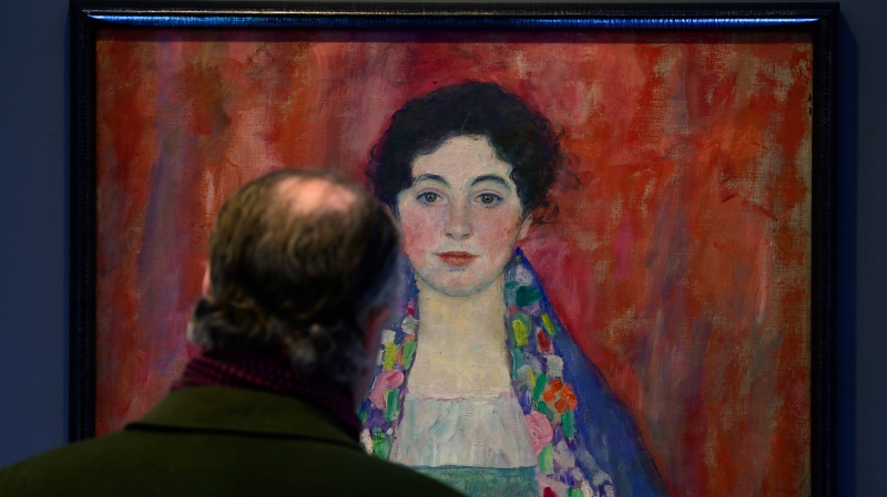 A man looks at the painting 'Portrait of Fräulein Lieser' by Austrian painter Gustav Klimt prior to an auction, in Vienna, Wednesday, April 24, 2024. (Christian Bruna / AP Photo)