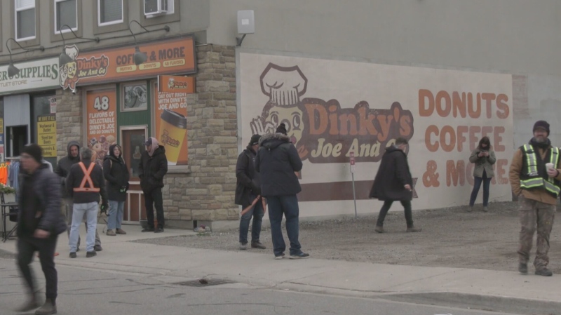 A film crew sets up in front of Cyprianna's Pizzeria on Queen Street in Cambridge on April 24, 2024. The restaurant was transformed into “Dinky’s Joe and Go” for the one-day shoot. (Chris Thomson/CTV Kitchener)