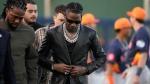 Rapper and producer Travis Scott prepares to throw out the first pitch before the start of a spring training baseball game between the Washington Nationals and the Houston Astros Saturday, Feb. 24, 2024, in West Palm Beach, Fla. (Jeff Roberson / AP Photo)