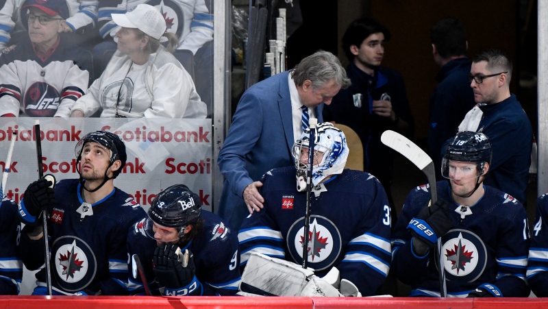 Winnipeg Jets' head coach Rick Bowness speaks with goaltender Connor Hellebuyck (37) after he was pulled for the extra attacker at the end of the third period against the Colorado Avalanche in Game 2 of their NHL hockey Stanley Cup first-round playoff series in Winnipeg, Tuesday April 23, 2024. ("The Canadian Press)