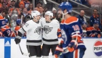 Los Angeles Kings' Kevin Fiala (22) and Jordan Spence (21) celebrate a goal against the Edmonton Oilers during third period NHL playoff action in Edmonton on Wednesday April 24, 2024 (Jason Franson / The Canadian Press)