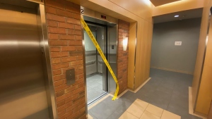 Yellow police tape cordons off an elevator at a rental building near Church and Shuter streets Thursday April, 25, 2024, a day after someone died following a fall from a balcony there. (CTV News Toronto)