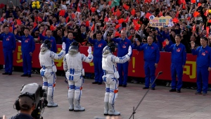 Chinese astronauts for the Shenzhou-18 mission, from left, Li Guangsu, Ye Guangfu and Li Cong wave as they attend a send-off ceremony for their manned space mission at the Jiuquan Satellite Launch Center in northwestern China, Thursday, April 25, 2024. (AP Photo/Andy Wong)