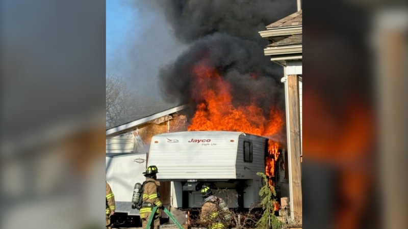 Crews battle a fire inside a trailer parked in a St. Thomas, Ont. driveway. April 25, 2024. (Source: St. Thomas fire)