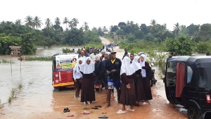Schoolchildren stranded on a damaged River Zingiziwa bridge in Dar Esalaam, Tanzania Thursday, April 25, 2024. (AP Photo)