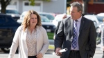 MLA’s Tammy Scott-Wallace and Mike Holland arrive at the New Brunswick Legislative Building in Fredericton on Tuesday, Oct. 17, 2023. THE CANADIAN PRESS/Ron Ward