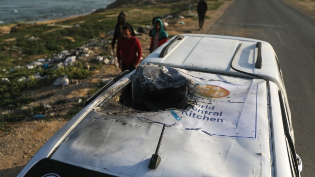 FILE - Palestinians inspect a vehicle with the logo of the World Central Kitchen wrecked by an Israeli airstrike in Deir al Balah, Gaza Strip on April 2, 2024. (Ismael Abu Dayyah / AP Photo, File)