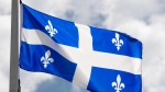Quebec's provincial flag flies in Ottawa, Friday, July 3, 2020. (Adrian Wyld/The Canadian Press)