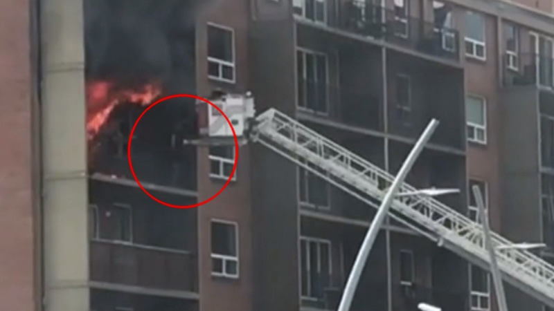 A person is rescued from the balcony of a burning apartment building in Edmonton on April 25, 2024. (Sean Amato/CTV News Edmonton)