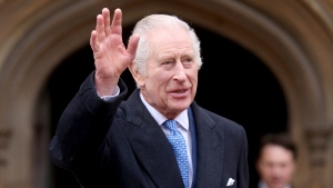 Britain's King Charles III waves as he leaves after attending the Easter Matins Service at St. George's Chapel, Windsor Castle, England, Sunday, March 31, 2024. (Hollie Adams / Pool Photo / Associated Press)