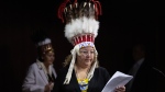 National Chief of the Assembly of First Nations Cindy Woodhouse Nepinak places her papers on the podium at the start of a news conference on Parliament Hill, Wednesday, April 17, 2024 in Ottawa. THE CANADIAN PRESS/Adrian Wyld