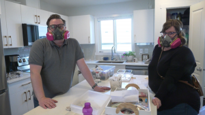 Elden and Karen McNaughton wear respirators inside their newly built Sherwood Park, Alta home. (Nav Sangha/CTV News Edmonton)