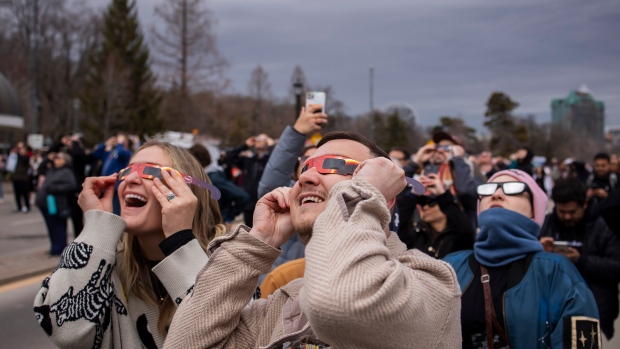 People watch the total solar eclipse in Niagara Falls, Ont., on Monday, April 8, 2024. THE CANADIAN PRESS/Aaron Lynett