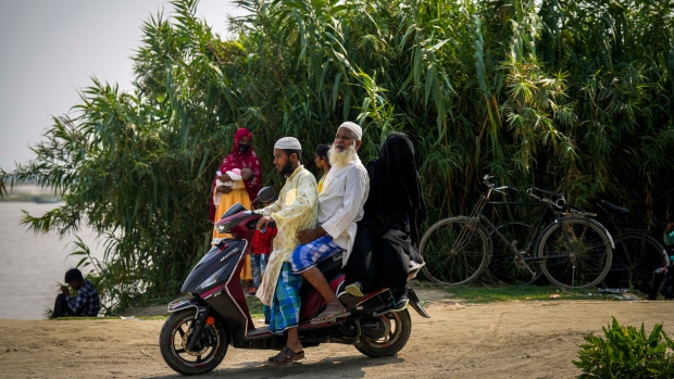 A family on a scooter leaves after casting their votes at a polling station. (AP Photo/Anupam Nath)
