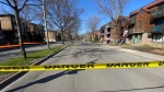 Police tape blocks off a street in Montreal's Rosemont-La Petite-Patrie borough after sticks of dynamite were found outside a residential building on Friday, April 26, 2024. (Matt Grillo/CTV News)