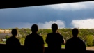 From left; Ally Mercer, Gabe Sedlacek Kaleb Andersen and Austin Young watch a tornado from a seventh floor parking garage on Friday, April 26, 2024, in Lincoln, Neb. (Kenneth Ferriera / Lincoln Journal Star via AP)