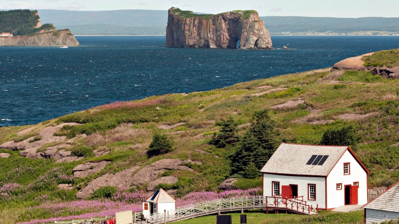 Tens of thousands of visitors flock to Quebec's storied Iles-de-la-Madeleine every summer to behold its cliff-framed seascapes and wide sandy beaches. But starting next month, those island sojourns will come with an added cost. The Bonaventure Island is shown overlooking the Perce rock on July 25, 2012. THE CANADIAN PRESS/Jacques Boissinot

