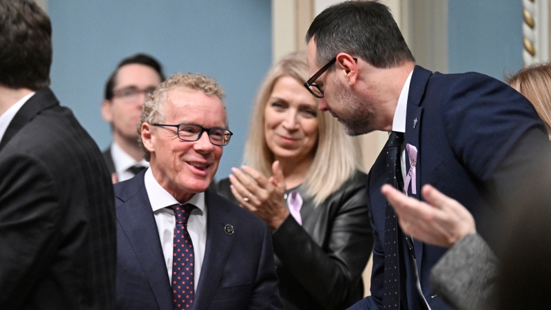 Quebec Labor Minister Jean Boulet receives congratulations from his colleague Jean-Francois Roberge at the National Assembly. Photo taken February 1, 2024. LA PRESSE CANADIENNE/Jacques Boissinot
