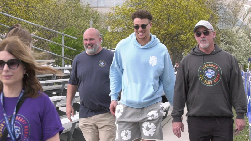 Theo Johnson, second from right, approaches an outdoor autograph signing in Windsor, Ont. about an hour after being selected by the New York Giants in the 2024 NFL Draft on Apr. 27, 2024. (Sanjay Maru/CTV News Windsor)