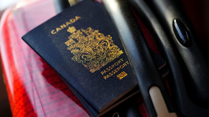 A Canadian passport sits on a suitcase in Ottawa on Tuesday, Jan. 17, 2023. Social development minister Karina Gould says Service Canada has "virtually eliminated" the backlog of thousands of passport applications. THE CANADIAN PRESS/Sean Kilpatrick

