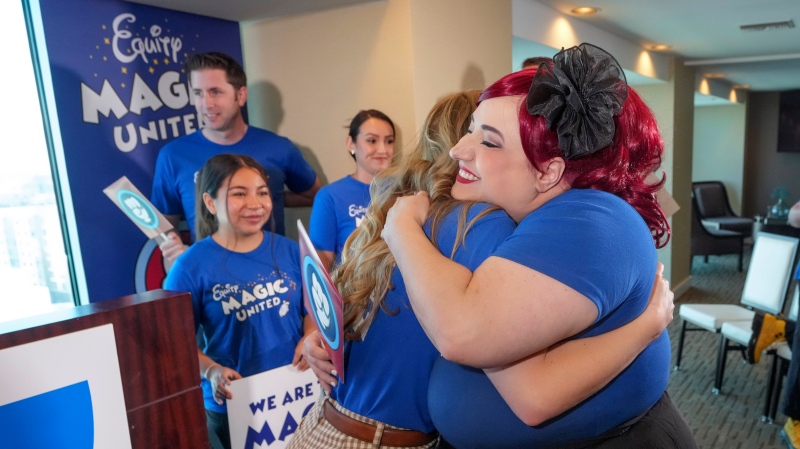 Disneyland Resort Cast Members, Courtney Griffith, left, hugs Angela Nichols after a news conference in Anaheim, Calif., Wednesday, April 17, 2024. (AP Photo/Damian Dovarganes)