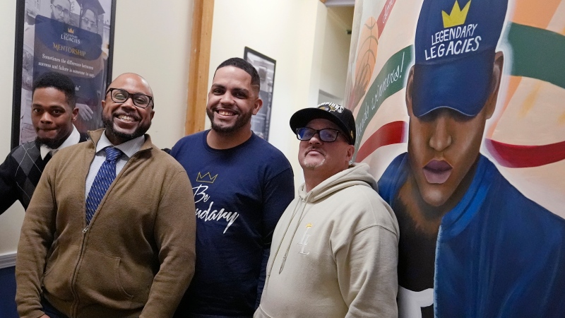 Ron Waddell, Founder and Executive Director of Legendary Legacies, second from left, poses with men benefitting from his nonprofit organization, Friday, April 19, 2024, in Worcester, Mass. (AP Photo/Charles Krupa)