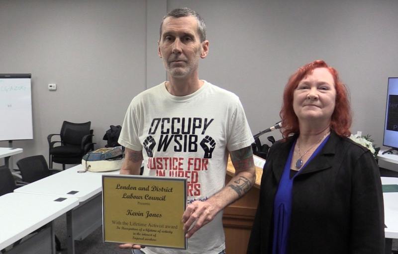 Kevin Jones (left) was honoured with the Lifetime Activism Award by Patti Dalton, president of the London and District Labour Council during the National Day of Mourning in London, Ont. on April 28, 2024. (Brent Lale/CTV News London)