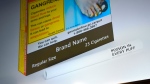 An example of cigarette packaging with expanded warnings. (Justin Tang / The Canadian Press)