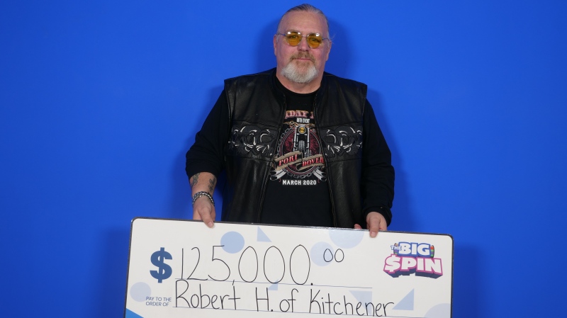 Robert Hain poses with a novelty cheque after winning $125,000 with OLG's The Big Spin. (Submitted: OLG)