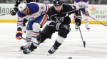 Edmonton Oilers winger Evander Kane, left, swipes for the puck as he chases Los Angeles Kings defenceman Drew Doughty on April 28, 2024, during Game 4 of their Stanley Cup first-round playoff series. (Mark J. Terrill/The Associated Press)