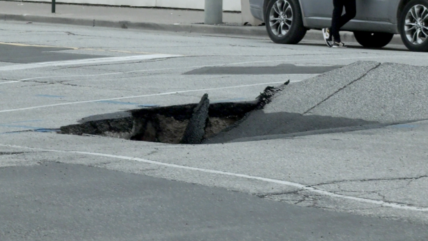 A sinkhole appeared at the corner of University Avenue West and Church Street on April 29, 2024. (Rich Garton/CTV News Windsor) 
