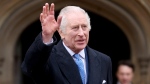 King Charles III waves as he leaves after attending the Easter Matins Service at St. George's Chapel, Windsor Castle, England, March 31, 2024. (Hollie Adams/Pool Photo via AP)