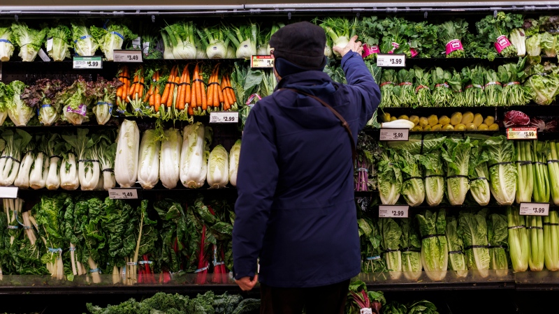 A customer shops for produce at a grocery store In Toronto on Friday, Feb. 2, 2024. THE CANADIAN PRESS/Cole Burston