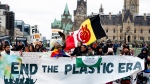 People take part in a 'March to End the Plastic Era' rally on Parliament Hill in Ottawa, on Sunday, April 21, 2024. THE CANADIAN PRESS/Spencer Colby