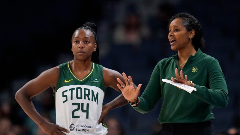 Seattle Storm guard Jewell Loyd (24) and head coach Noelle Quinn talk during the first half of a WNBA basketball game against the Minnesota Lynx, Tuesday, June 27, 2023, in Minneapolis. (AP Photo/Abbie Parr)