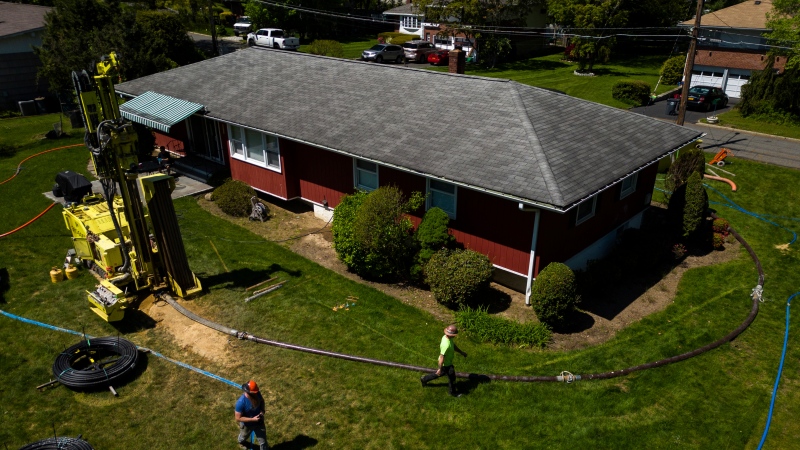 A drill rig for a geothermal heat pump sits outside a home in White Plains, N.Y., Monday, May 8, 2023. Industry experts see the technology becoming increasingly popular in the coming years. (AP Photo/Julia Nikhinson)
