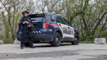 An Waterloo regional police officer guards the entrance to a trail along the Grand River off of Mill Park Drive in Kitchener on April 30, 2024. (Dan Lauckner/CTV Kitchener)