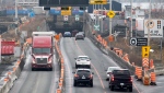 Vehicles enter and exit the Louis-Hippolyte-La Fontaine Tunnel on the south shore of Montreal, Monday, January 2, 2023. (Graham Hughes, The Canadian Press)
