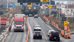 Vehicles enter and exit the Louis-Hippolyte-La Fontaine Tunnel on the south shore of Montreal, Monday, January 2, 2023. (Graham Hughes, The Canadian Press)