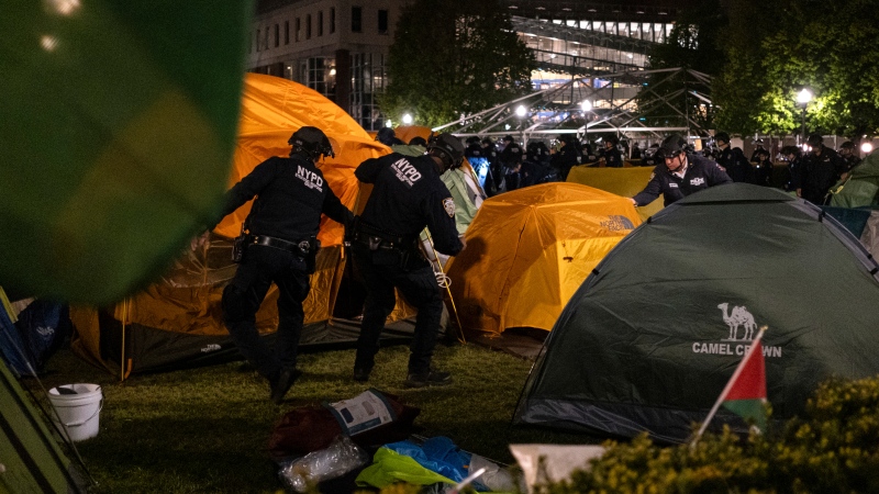 Officers with the New York Police Department raid the encampment by pro-Palestinian protesters at Columbia University on Tuesday, April 30, 2024, in New York. (Marco Postigo Storel via AP)