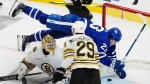 Toronto Maple Leafs' Matthew Knies (23) falls as he scores on Boston Bruins goaltender Jeremy Swayman (1) during second period action in Game 3 of an NHL hockey Stanley Cup first-round playoff series in Toronto on Wednesday, April 24, 2024. THE CANADIAN PRESS/Frank Gunn