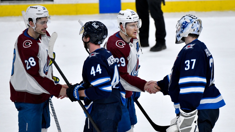 Colorado Avalanche's Miles Wood (28) and Nathan MacKinnon (29) shake hands with Winnipeg Jets' Josh Morrissey (44) and goaltender Connor Hellebuyck (37) after Game 5 of their NHL hockey Stanley Cup first-round playoff series in Winnipeg, Tuesday April 30, 2024. THE CANADIAN PRESS/Fred Greenslade