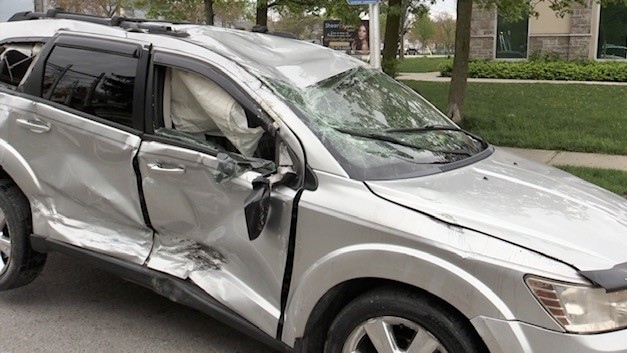A damaged SUV is seen moments after it was rolled back on its wheels by a local towing company on May 1, 2024. (Sean Irvine/CTV News London)
