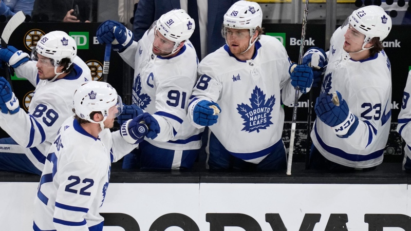 Toronto Maple Leafs defenseman Jake McCabe (22) is congratulated after his goal against Boston Bruins goaltender Jeremy Swayman during the first period of Game 5 of an NHL hockey Stanley Cup first-round playoff series, Tuesday, April 30, 2024, in Boston. (AP Photo/Charles Krupa)