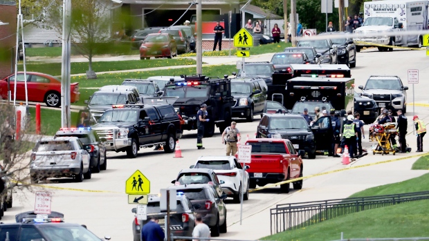 Law enforcement personnel respond to a report of a person armed with a rifle at Mount Horeb Middle School in Mount Horeb, Wis., Wednesday, May 1, 2024. (John Hart/Wisconsin State Journal via AP)