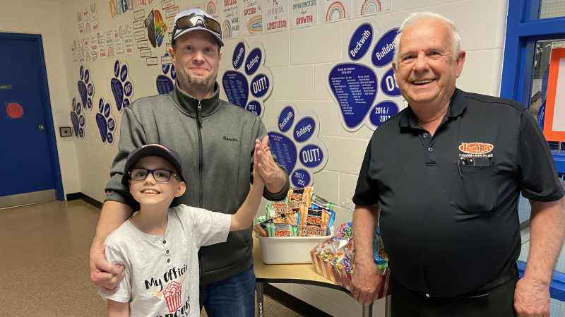 Caleb and Scott Bellefeuille at Beckwith Public School with Jacques Lalonde, president of Papa Jack Popcorn. May 1, 2024. (Dylan Dyson)